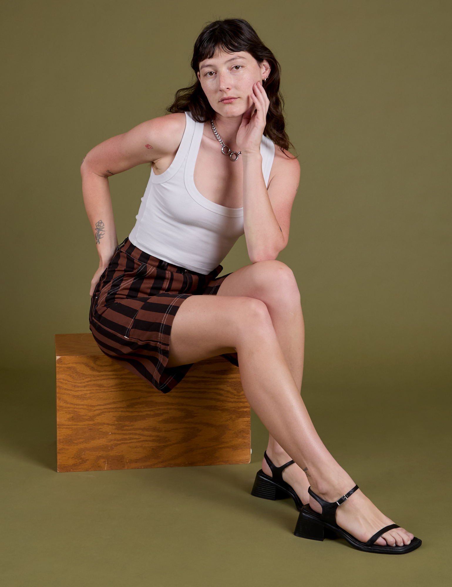 Alex is wearing Longline Work Shorts in Fudgesicle Brown and Cropped Tank in Vintage Tee White