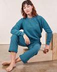 Alex is wearing Cropped Rolled Cuff Sweatpants in Marine Blue and matching Heavyweight Crew Sweatshirt