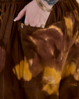 Close up of Sydney's hand in the back pocket of Magic Waters Drop Pocket Pants in Honey Brown