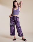 Alex is 5’8” and wearing XXS Magic Waters Drop Pocket Pants in Dark Lavender paired with faded grape Cropped Tank