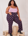 Angled front view of Western Pants in Purple Tile Jacquard and bubblegum pink Cami on Morgan
