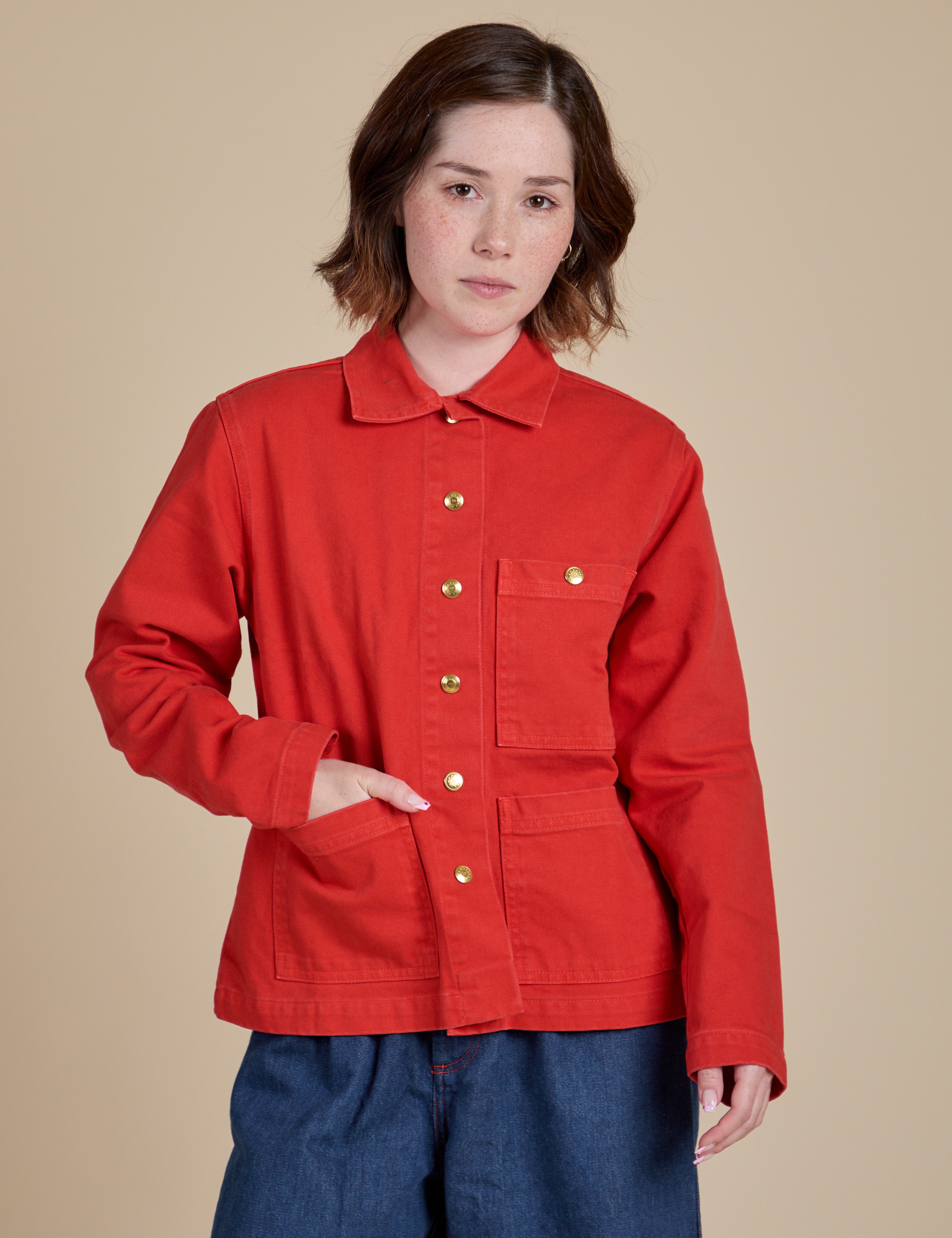 Hana is wearing a buttoned up Denim Work Jacket in Mustang Red