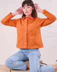 Denim Work Jacket in Construction Orange and light wash Carpenter Jeans on Alex