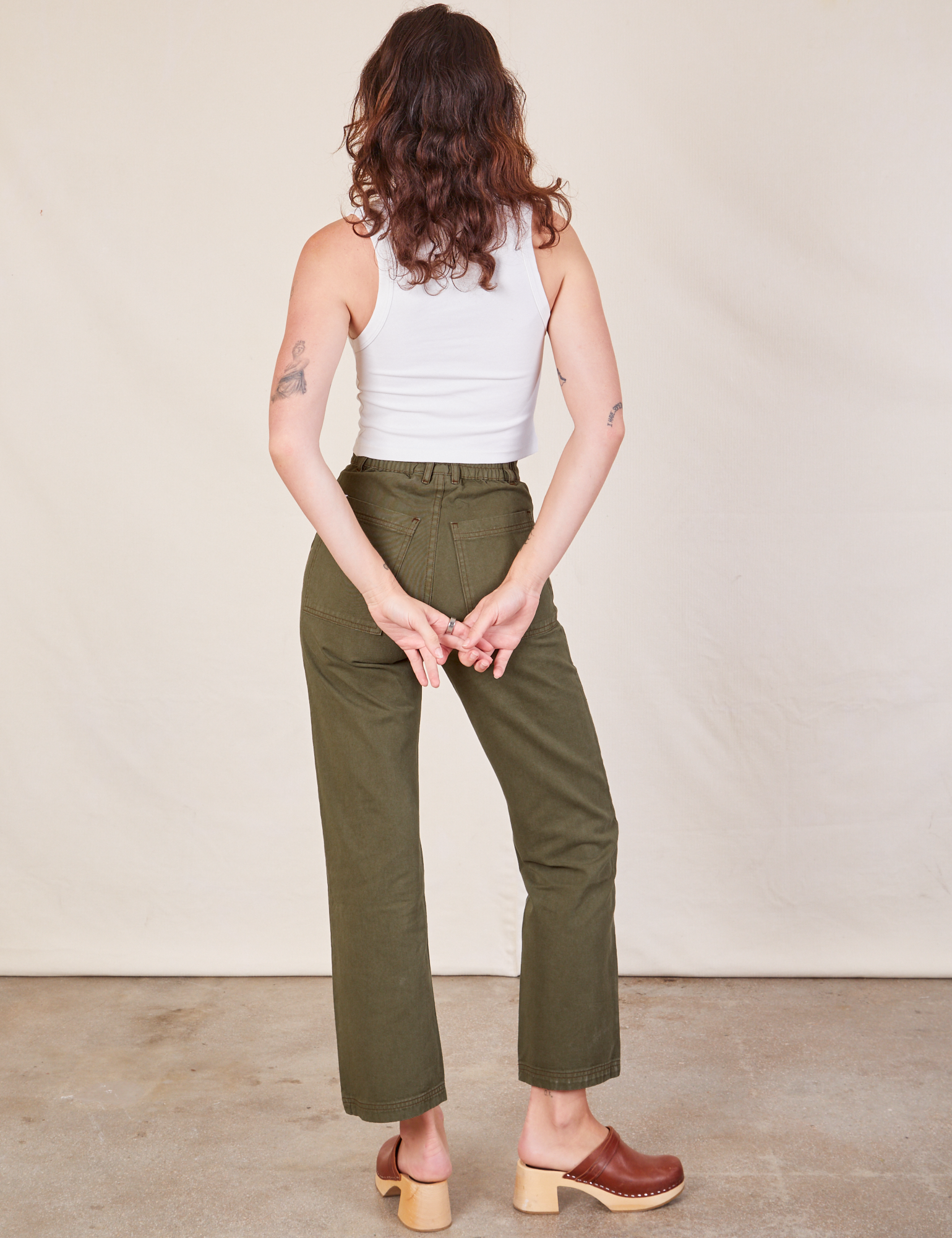 Back view of Work Pants in Surplus Green and Cropped Tank in vintage tee off-white on Alex