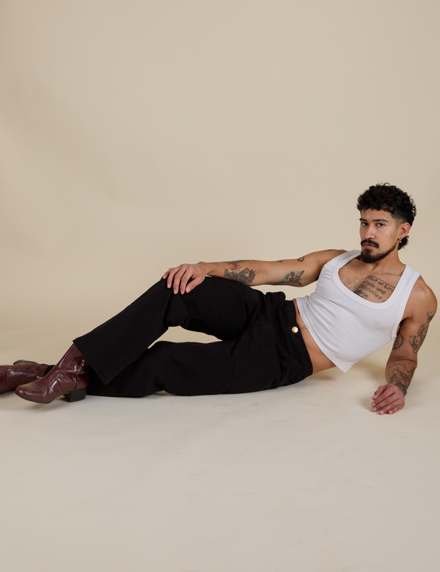 Jesse is wearing Work Pants in Basic Black and Cropped Tank in Vintage Tee White