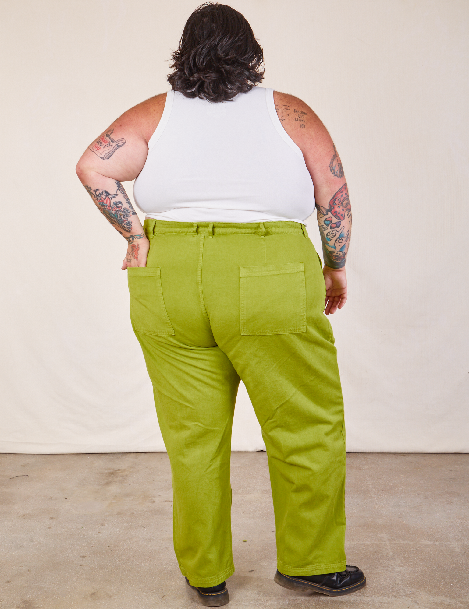 Back view of Work Pants in Gross Green and Cropped Tank in vintage tee off-white on Sam