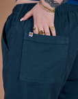 Close up of Sydney's hand in the back pocket of Action Pants in Lagoon