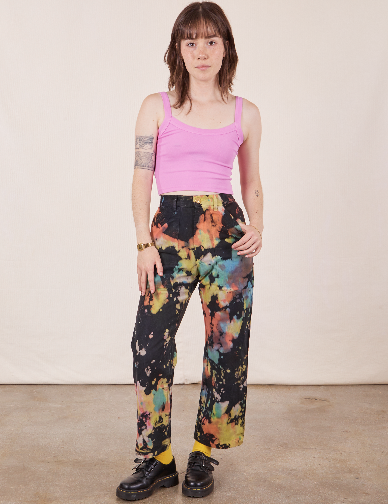 Hana is 5&#39;3&quot; and wearing XXS Petite Rainbow Magic Waters Work Pants paired with bubblegum pink Cropped Cami