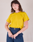 Burly Tee in Golden Yellow tucked into dark wash Denim Wide Leg Trousers on Alex