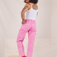 Back view of Carpenter Jeans in Bubblegum Pink worn by Jesse