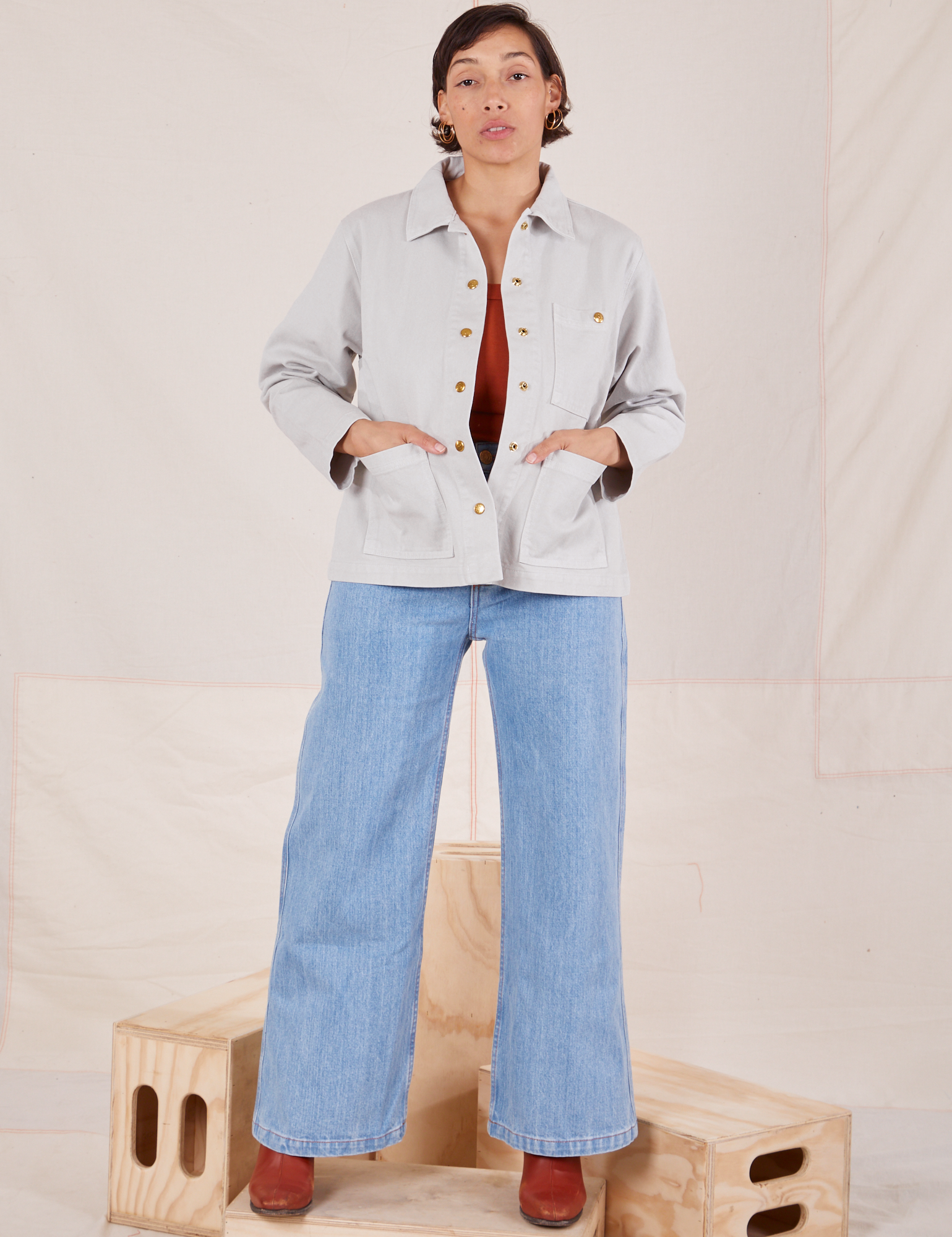 Tiara is wearing Denim Work Jacket in Dishwater White and light wash Sailor Jeans