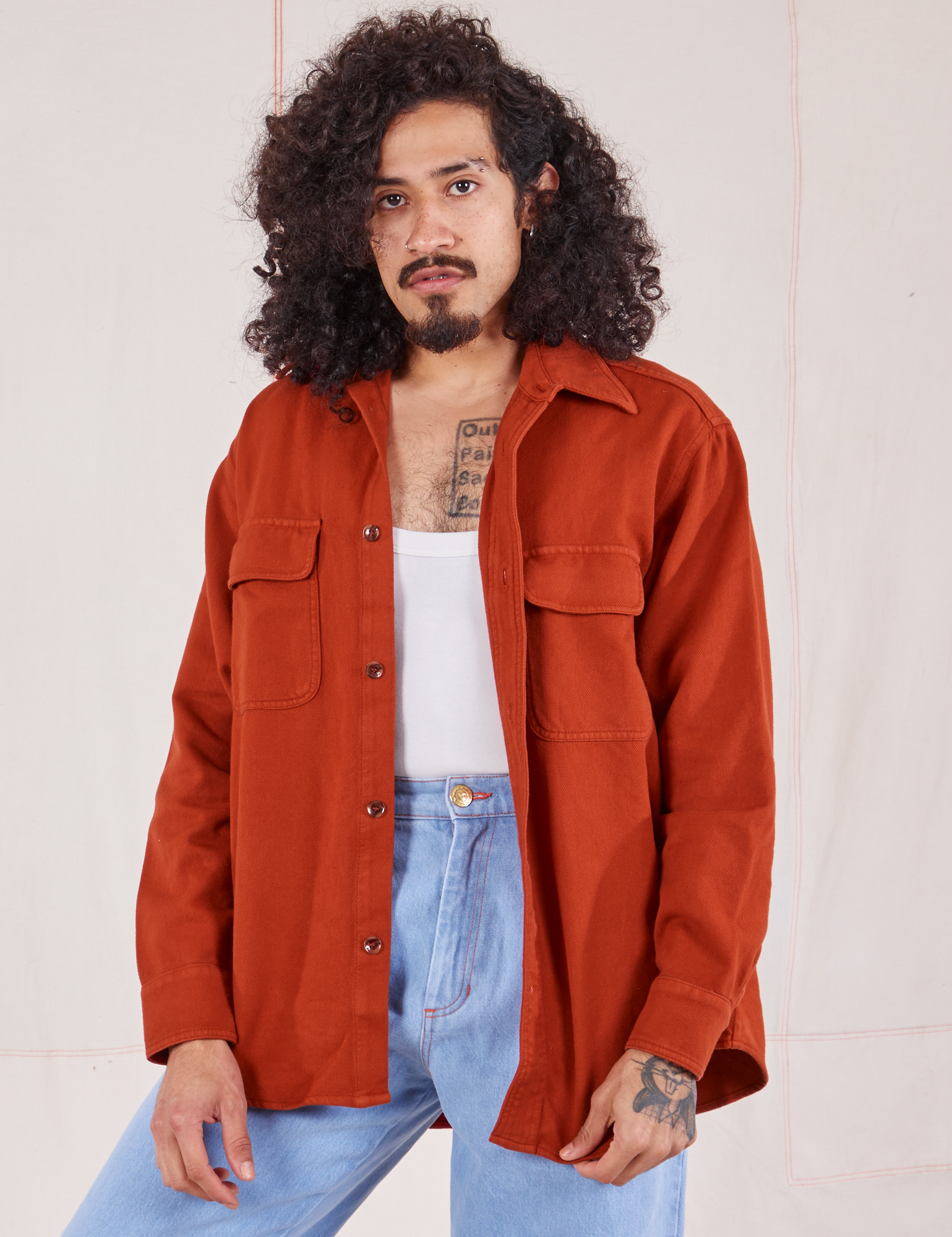 Jesse is wearing Flannel Overshirt in Paprika, vintage off-white Cropped Tank Top and light wash Trouser Jeans