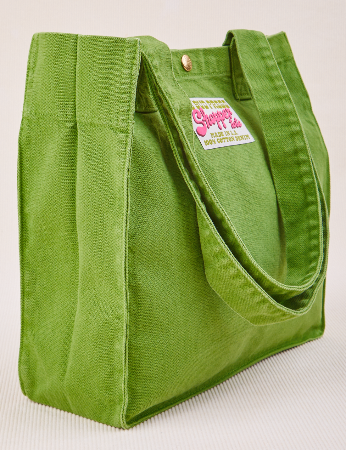 Angled view of Shopper Tote Bag in Bright Olive