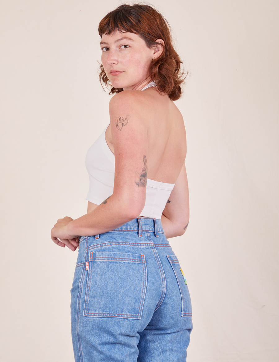 Angled back view of Halter Top in Vintage Off-White and light wash Frontier Jeans worn by Alex