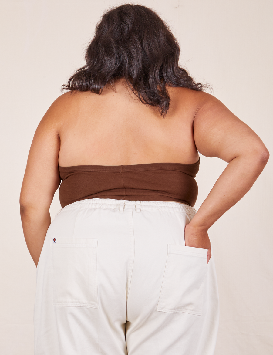 Back view of Halter Top in Fudgesicle Brown and vintage off-white Western Pants worn by Alicia. She has her left hand in the back pant pocket.