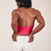 Back view of Halter Top in Hot Pink worn by Jerrod. They are also wearing vintage off-white Western Pants with both hands in the back pockets.