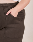 Cropped Rolled Cuff Sweatpants in Espresso Brown front pocket close up. Marielena has her hand in the pocket.
