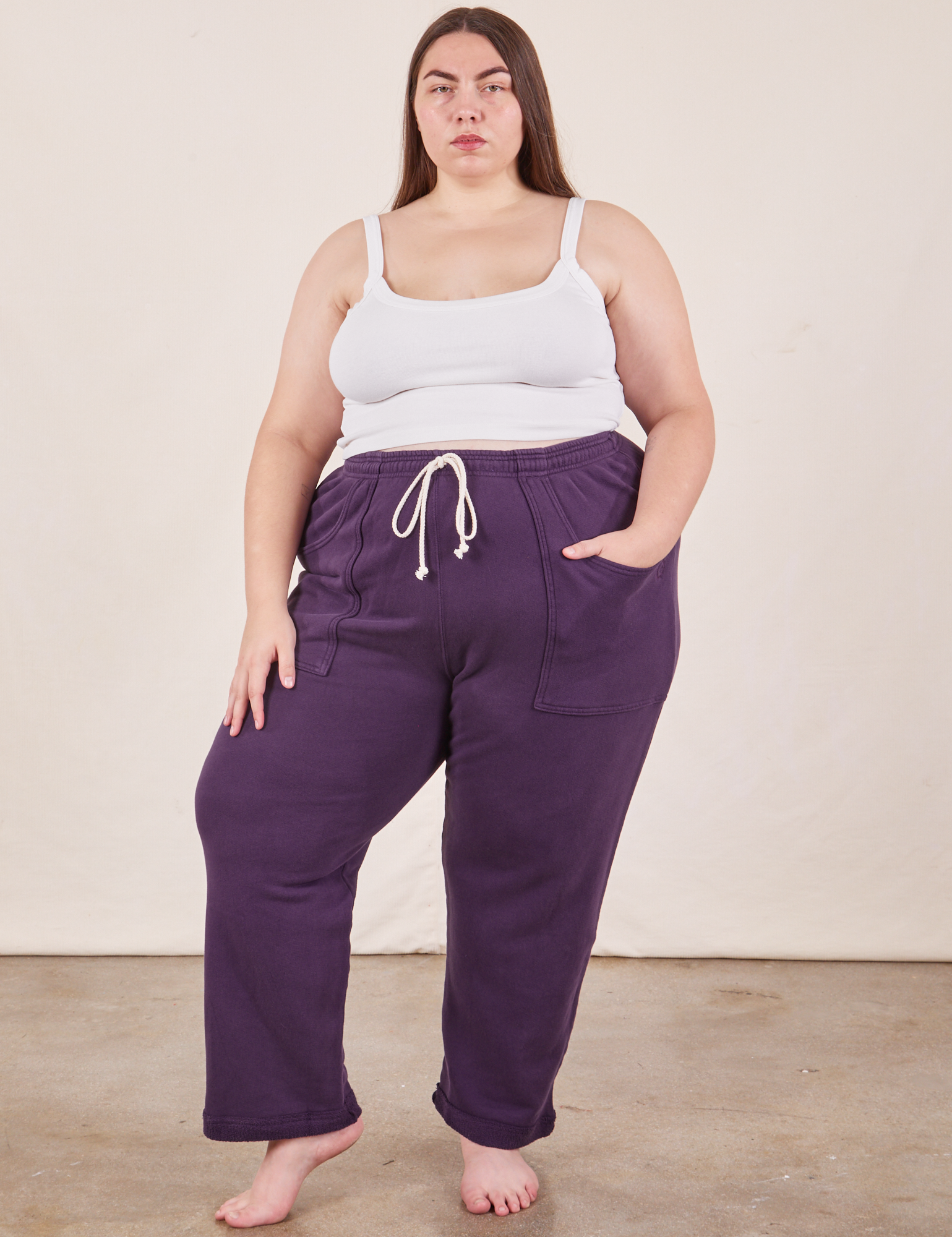 Marielena is 5&#39;8&quot; and wearing 2XL Cropped Rolled Cuff Sweatpants in Nebula Purple paired with vintage off-white Cami