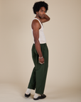 Side view of Heavyweight Trousers in Swamp Green  and Tank Top in Vintage Tee Off-White on Jerrod