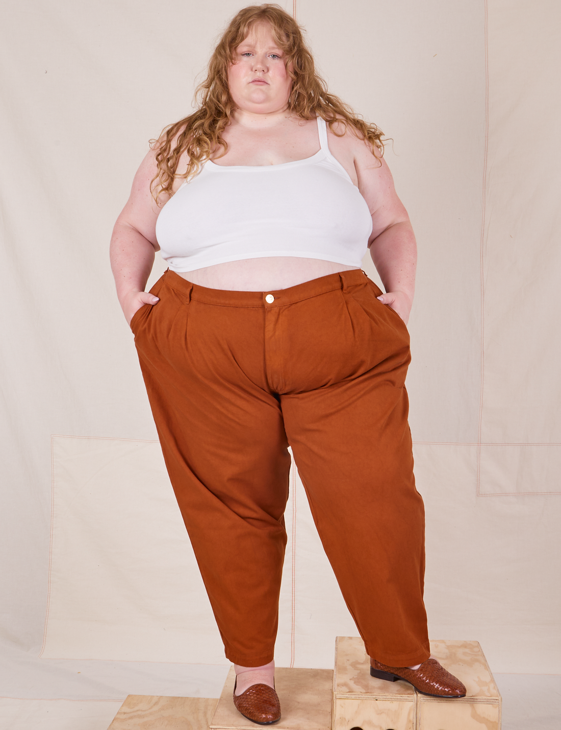 Catie is 5'11" and wearing 4XL Heavyweight Trousers in Burnt Terracotta paired with vintage off-white Cropped Cami
