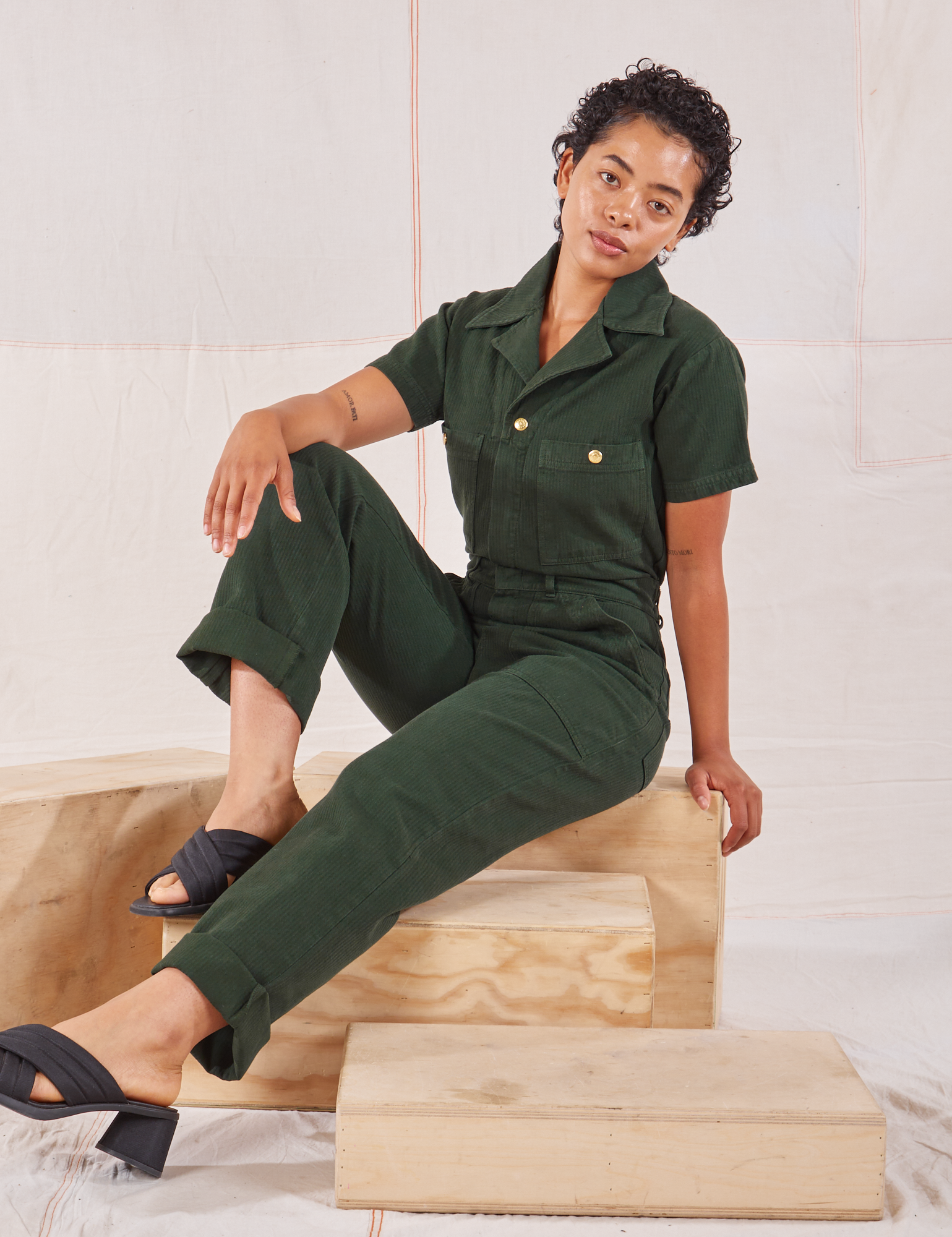 Mika is wearing Heritage Short Sleeve Jumpsuit in Swamp Green