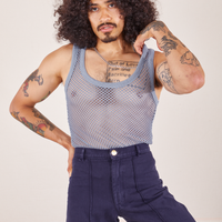 Jesse is 5'8" and wearing XS Mesh Tank Top in Periwinkle paired with navy Western Pants