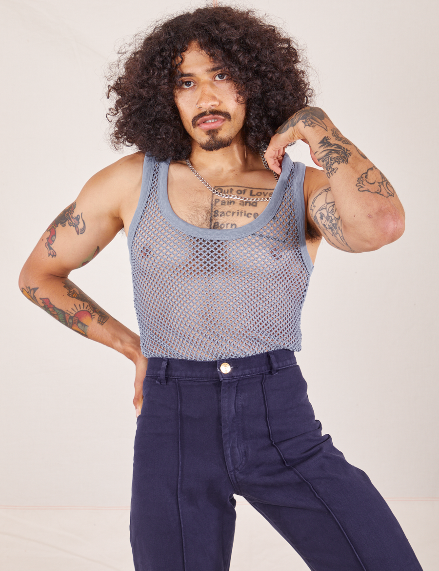Jesse is 5'8" and wearing XS Mesh Tank Top in Periwinkle paired with navy Western Pants