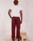 Back view of Mid-Rise Work Pants in Red Wine and Organic Vintage Tee in vintage tee off-white on Issac