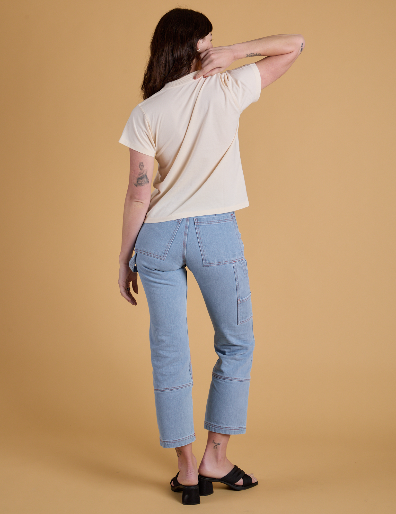 Back view of Organic Vintage Tee in Vintage Off White and light wash Carpenter Jeans on Alex