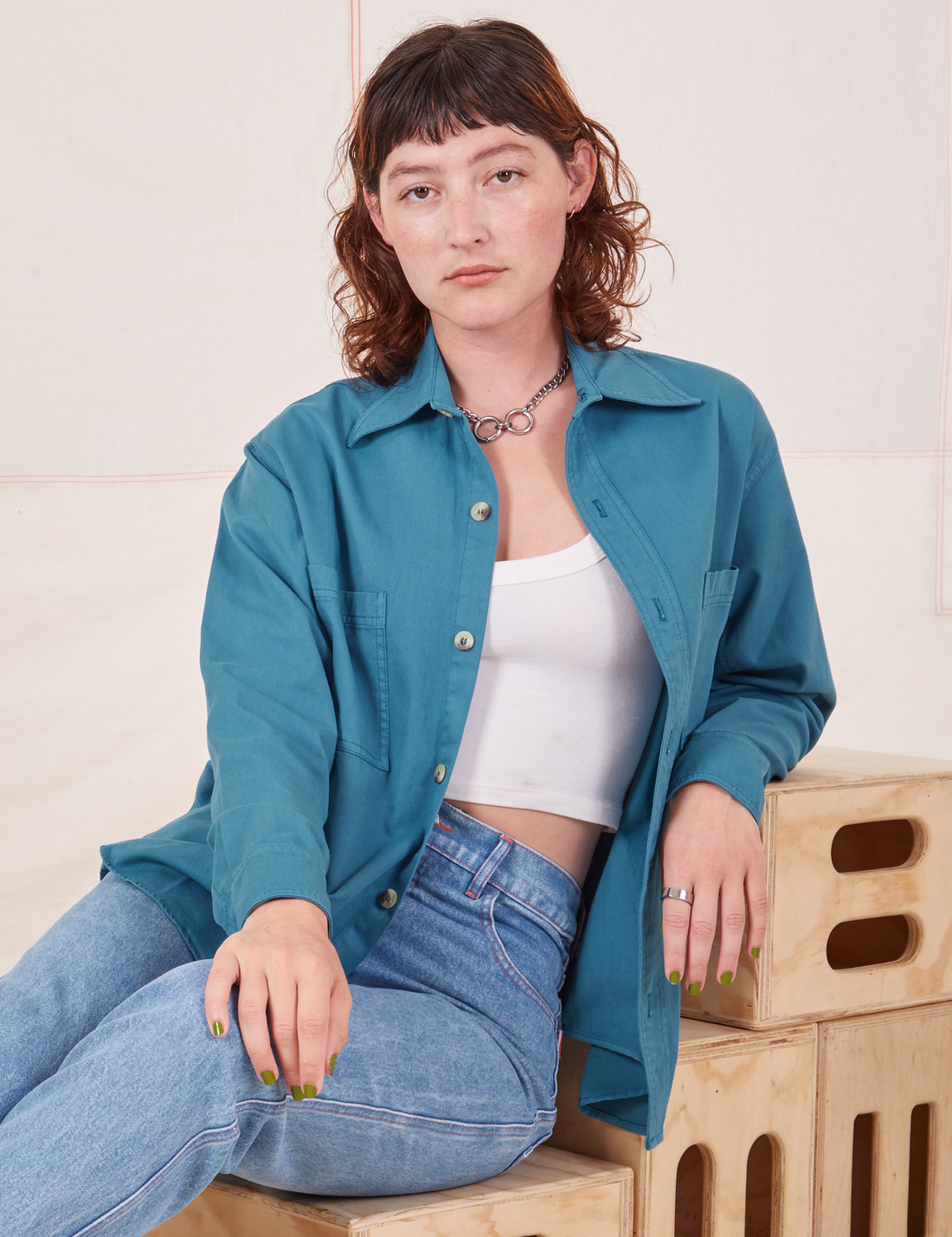 Alex is wearing Oversize Overshirt in Marine Blue with a vintage off-white Cropped Tank Top underneath