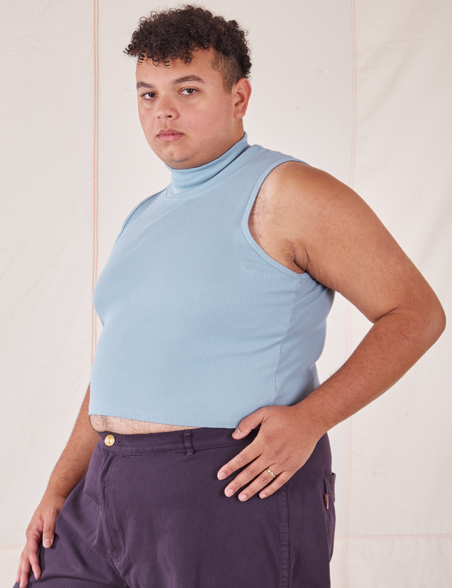 Angled front view of Sleeveless Essential Turtleneck in Periwinkle on Miguel
