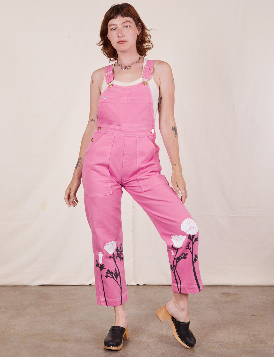 Alex is 5'8" and wearing P California Poppy Overalls in Bubblegum Pink with a vintage off-white Tank Top underneath