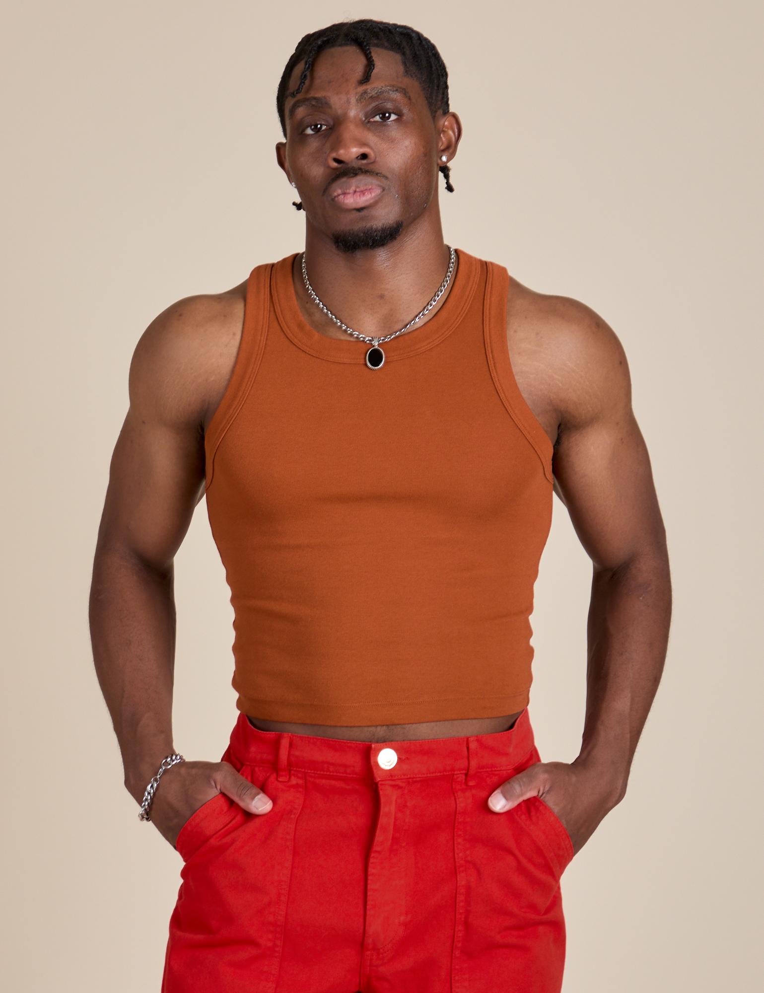 Isaac is 5’10” and wearing S Racerback Tank in Burnt Terracotta