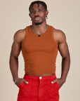 Isaac is 5’10” and wearing S Racerback Tank in Burnt Terracotta