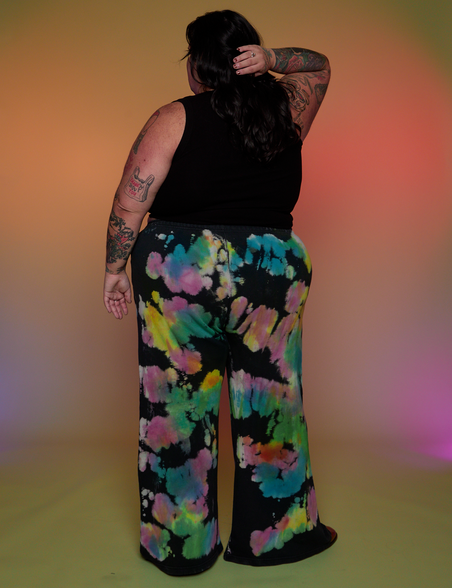Back view of Tie Dyed Wide Leg Sweat Pants and black Cropped Tank on Sam