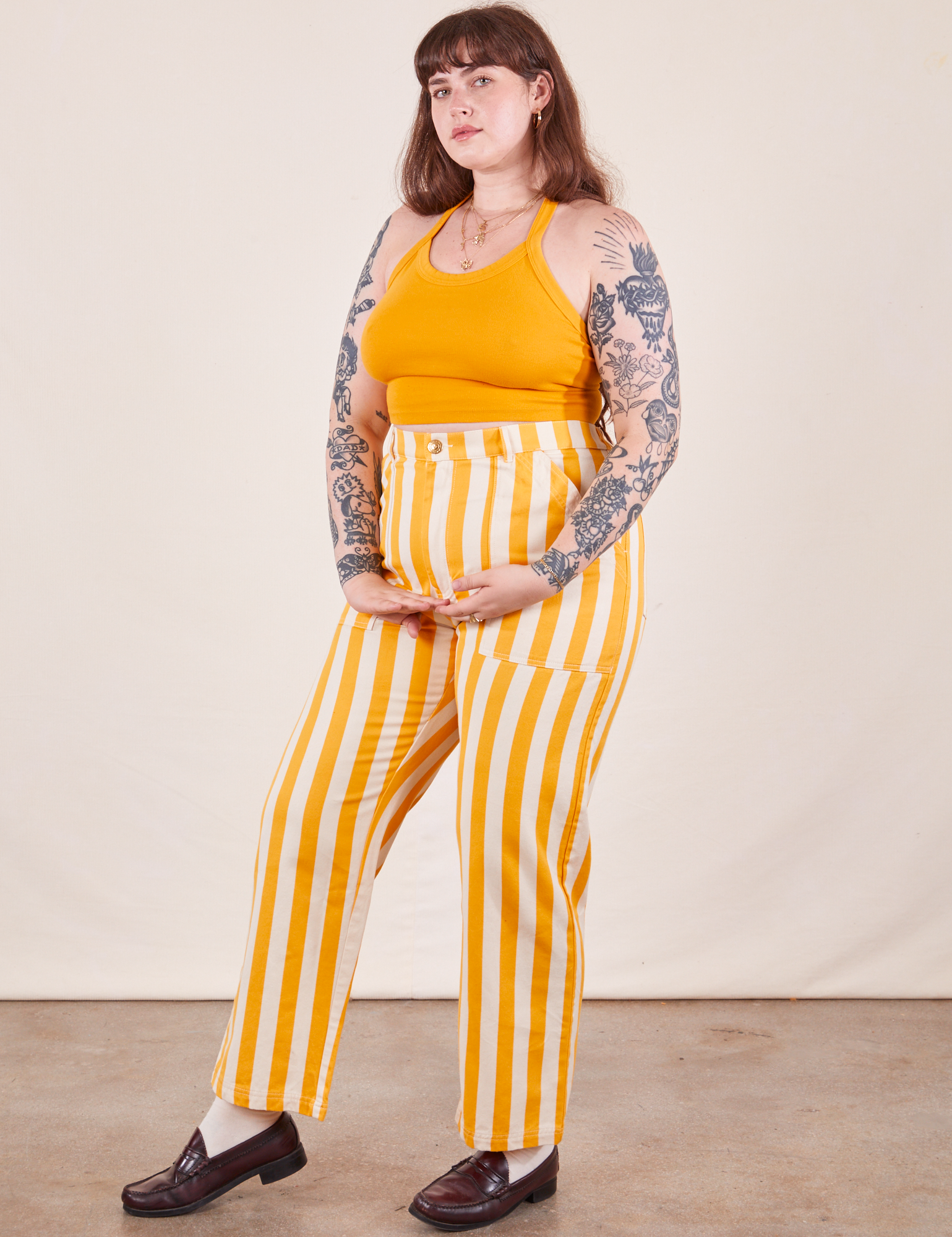 Angled view of Work Pants in Lemon Stripe and mustard yellow Halter Top on Sydney