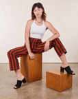 Alex is wearing Black Striped Work Pants in Paprika and vintage off-white Halter Top