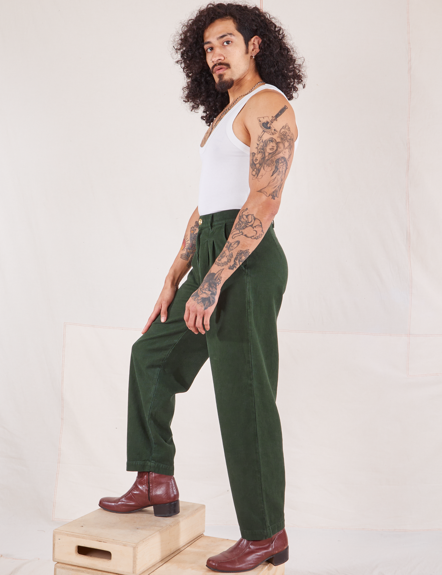 Side view of Heritage Trousers in Swamp Green and vintage off-white Cropped Tank Top