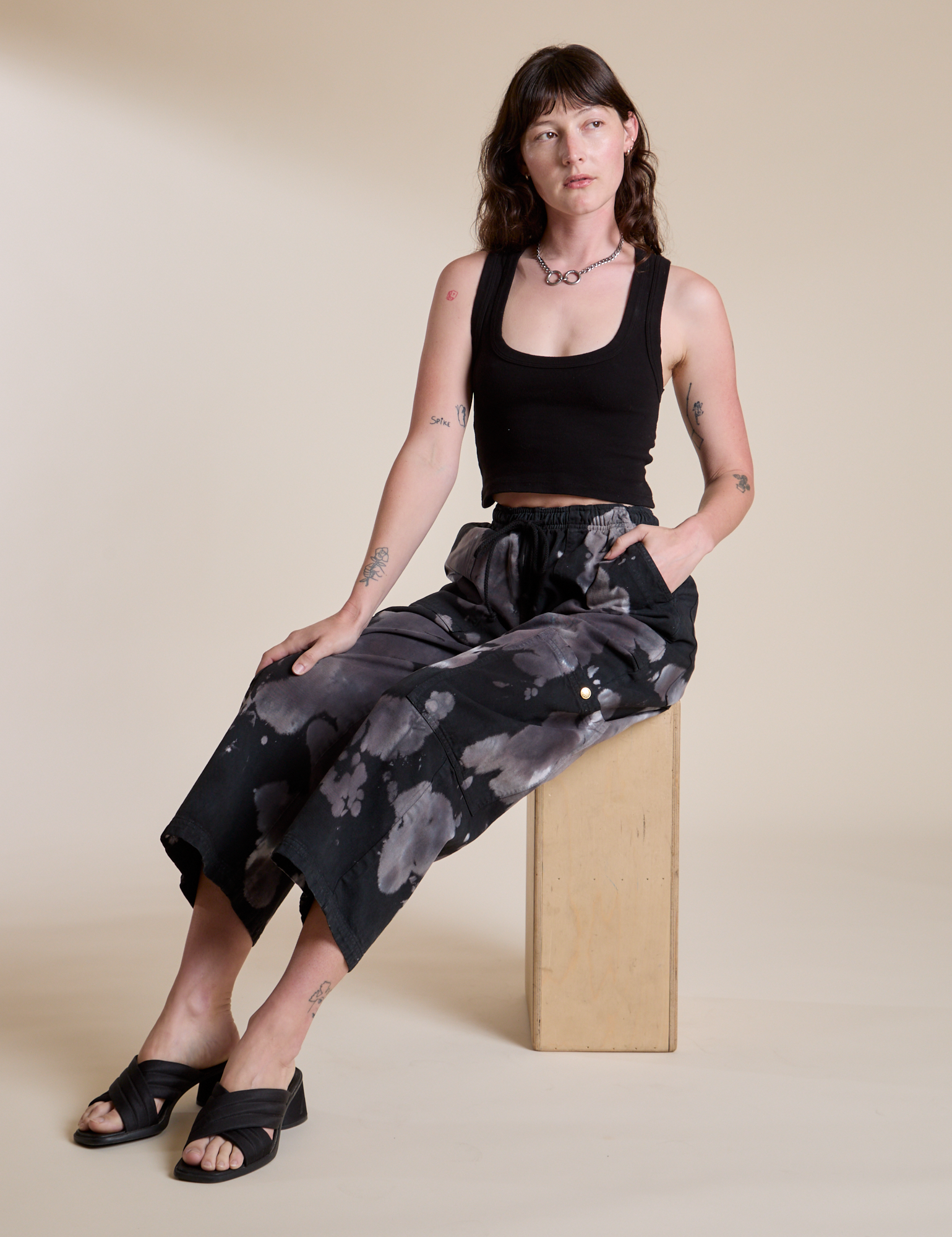 Magic Waters Drop Pocket Pants in Ink Blot and black Cropped Tank worn by Alex
