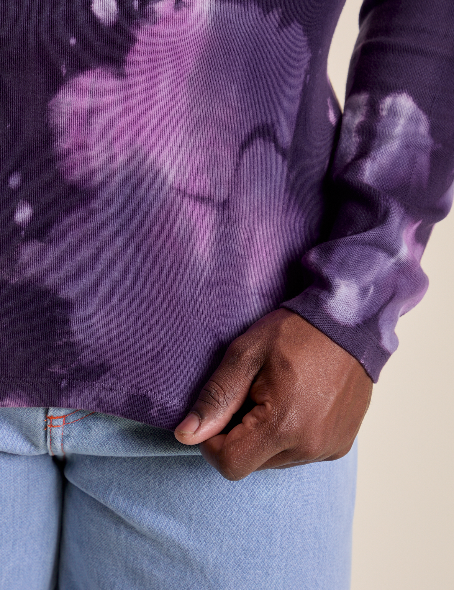 Long Sleeve Baby Tee in Dark Lavender bottom close up with Demi holding the hem