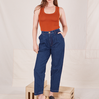 Allison is 5'10" and wearing XS Denim Trouser Jeans in Dark Wash paired with burnt orange Tank Top