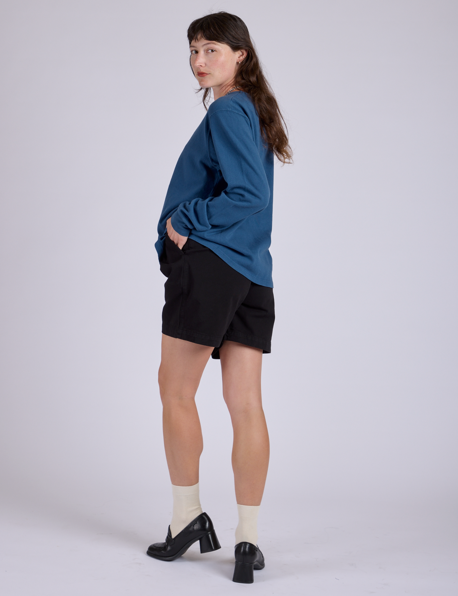 Pleated Trouser Shorts in Basic Black angled back view on Alex