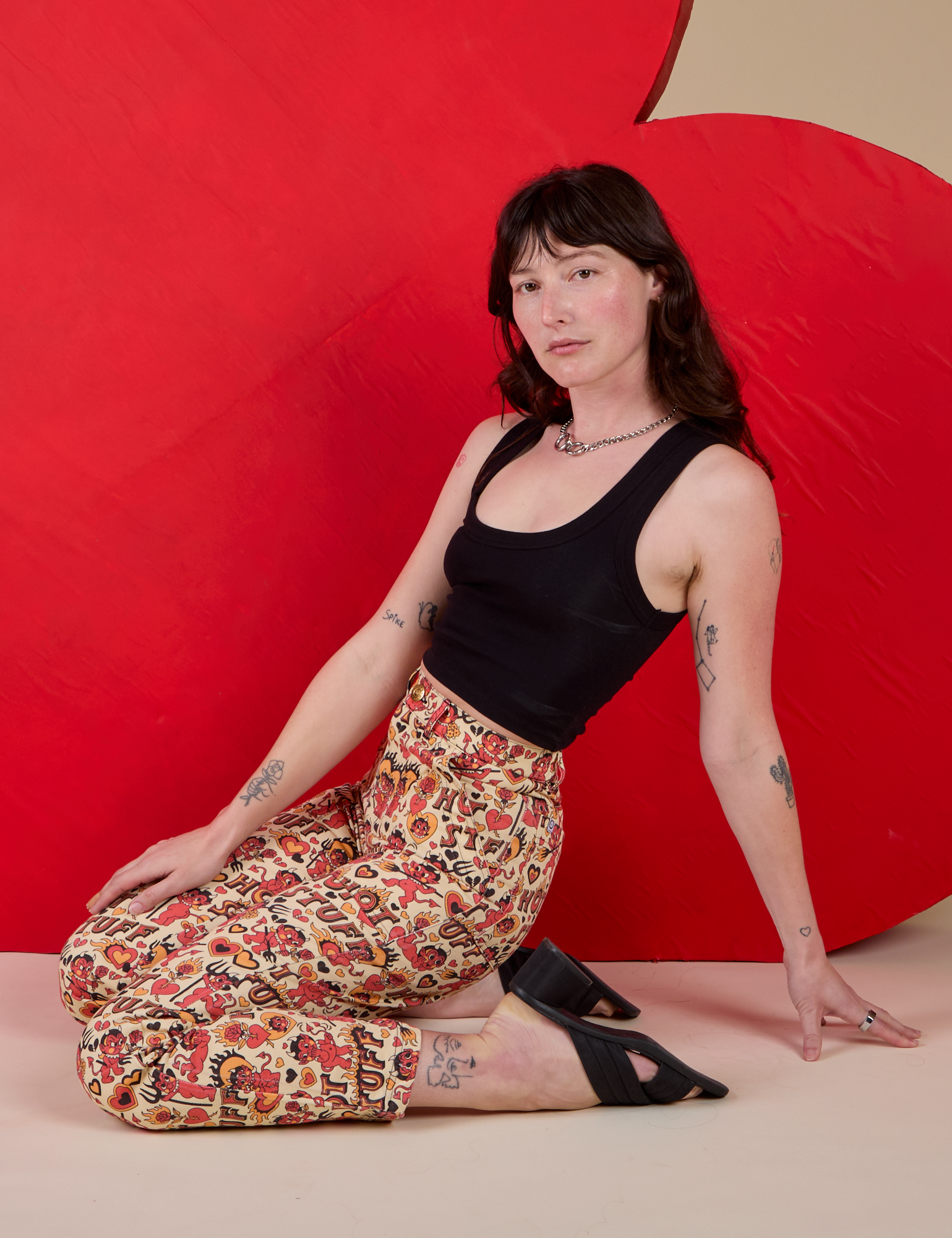 Work Pants in Hot Stuff Print and black Cropped Tank worn by Alex