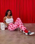 Kandia is wearing Paintstamped Heart Work Pants in Bubblegum Pink and vintage tee off-white Cami