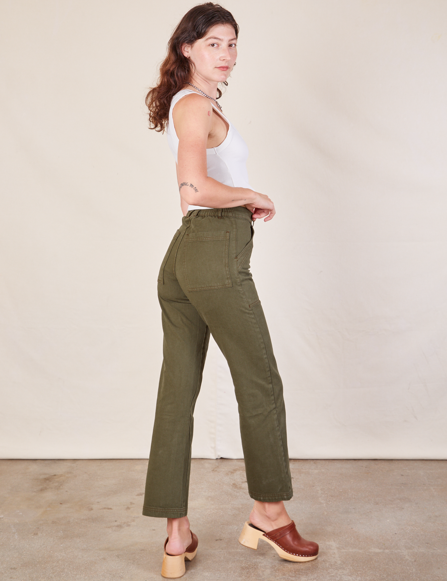 Angled back view of Work Pants in Surplus Green on Alex