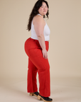 Side view of Work Pants in Mustang Red and Cropped Tank in Vintage Tee White on Ashley