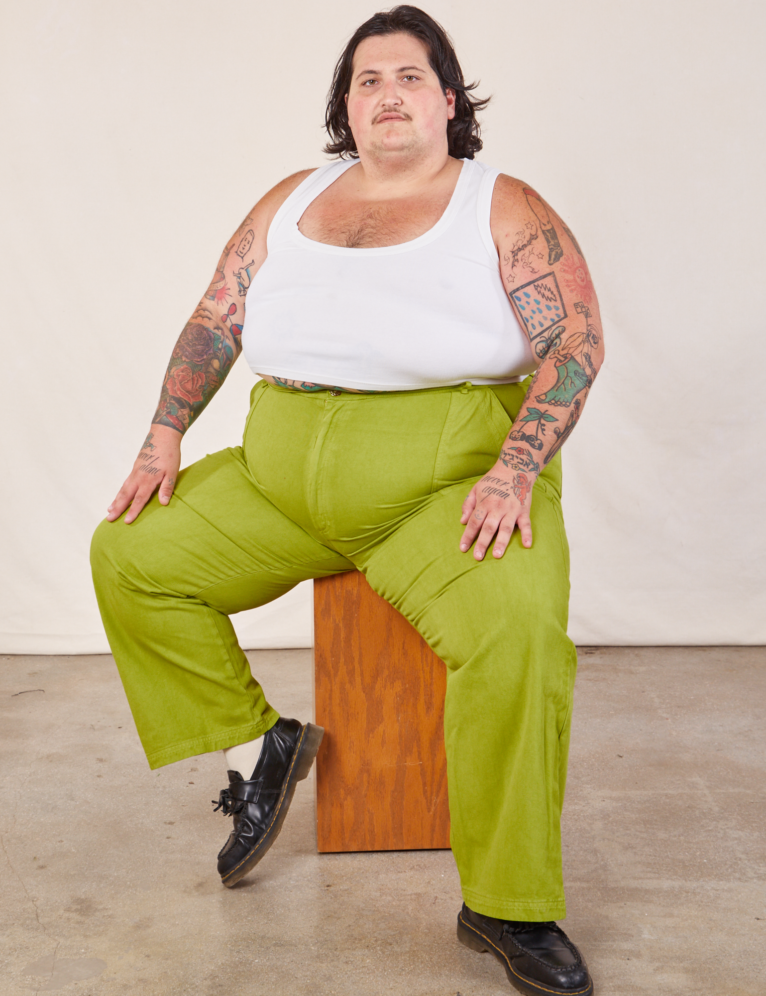 Sam is wearing Work Pants in Gross Green and Cropped Tank in vintage tee off-white