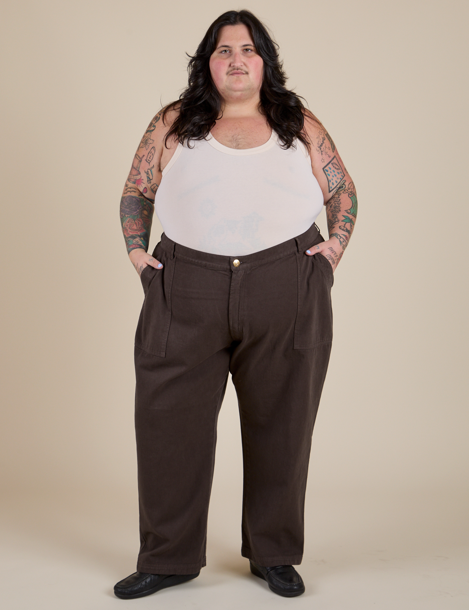 Sam is 5’10” and wearing 4XL Work Pants in Espresso Brown paired with a Tank Top in Vintage Tee Off-White