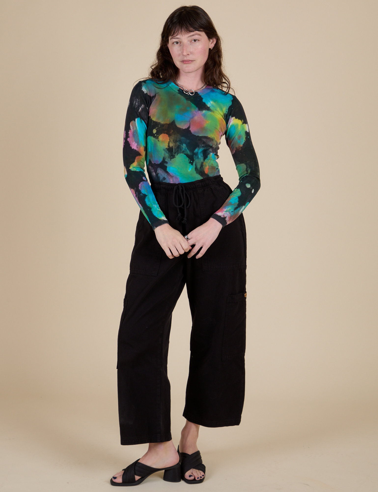 Long Sleeve Baby Tee in Rainbow Magic Waters and black Drop Pocket Cargo Pants on Alex