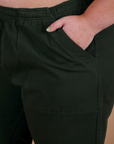 Close up of Juliet's hand in the front pocket of Action Pants in Swamp Green